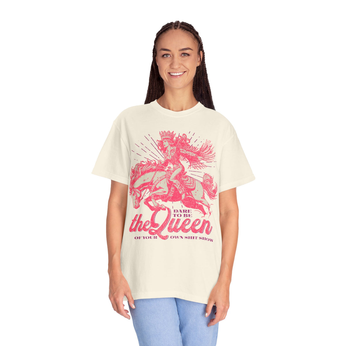 Black oversized t-shirt featuring a bold pink graphic of a cowgirl wearing a crown and fringe, riding a horse. Text reads “Dare to be the Queen of your own sh*t show.” Western-inspired, empowering design with a humorous twist.
