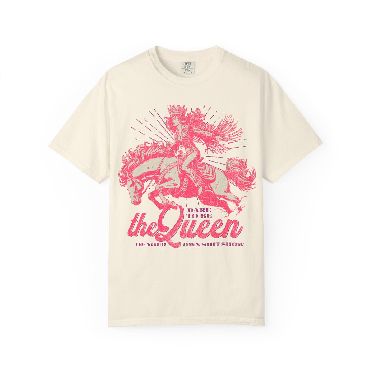 Black oversized t-shirt featuring a bold pink graphic of a cowgirl wearing a crown and fringe, riding a horse. Text reads “Dare to be the Queen of your own sh*t show.” Western-inspired, empowering design with a humorous twist.
